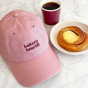 Alphabet Bags Bakery Tourist cocoa brown cotton baseball cap with pale pink embroidery.
