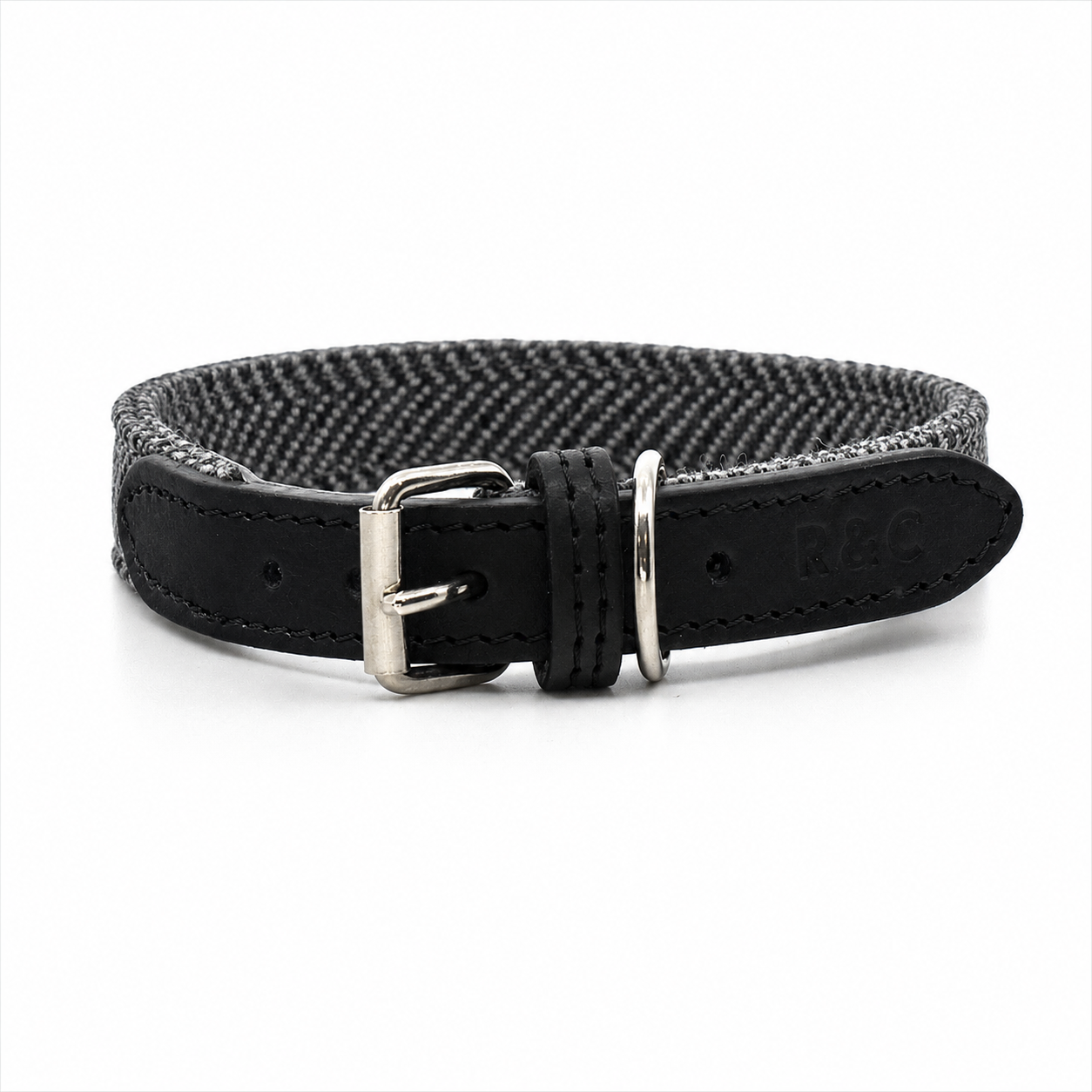 Close-up of Balmoral dog collar featuring grey herringbone fabric and black Italian leather