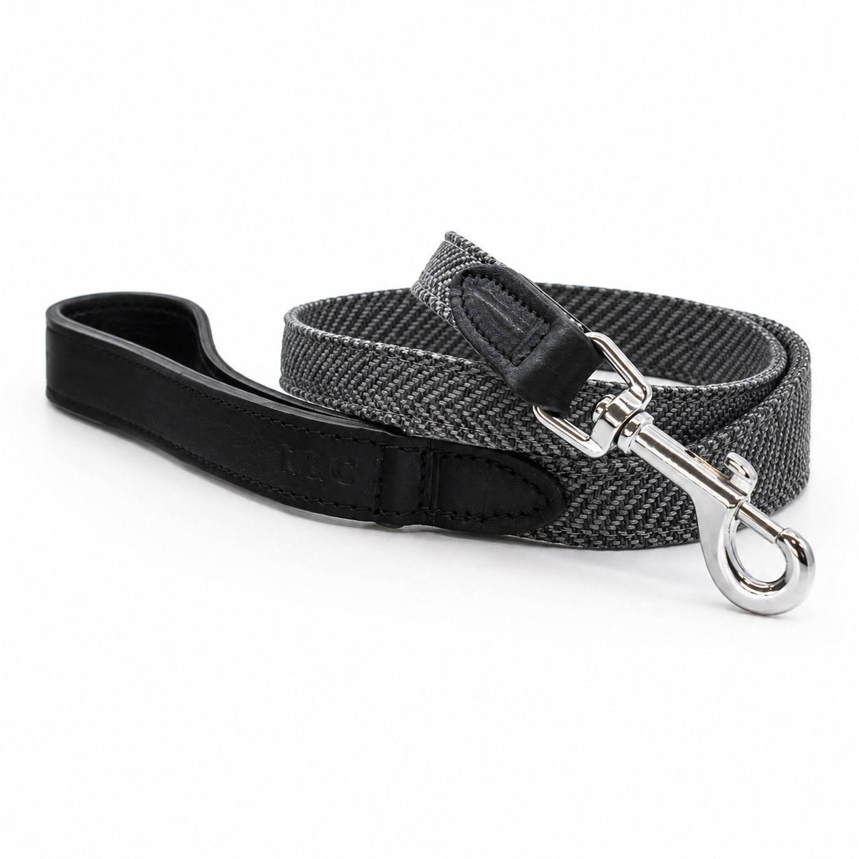 Close-up of Balmoral dog lead featuring grey herringbone fabric and black Italian leather