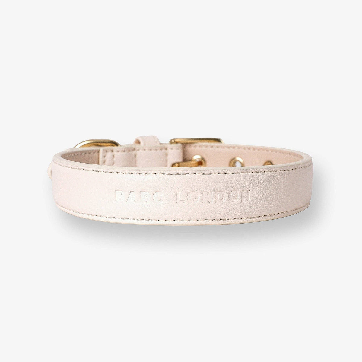 Neutral ivory Barc London dog collar with gold buckle and matching walking accessories.