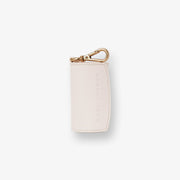 Barc London ivory vegan leather dog waste bag holder with gold-tone hardware.