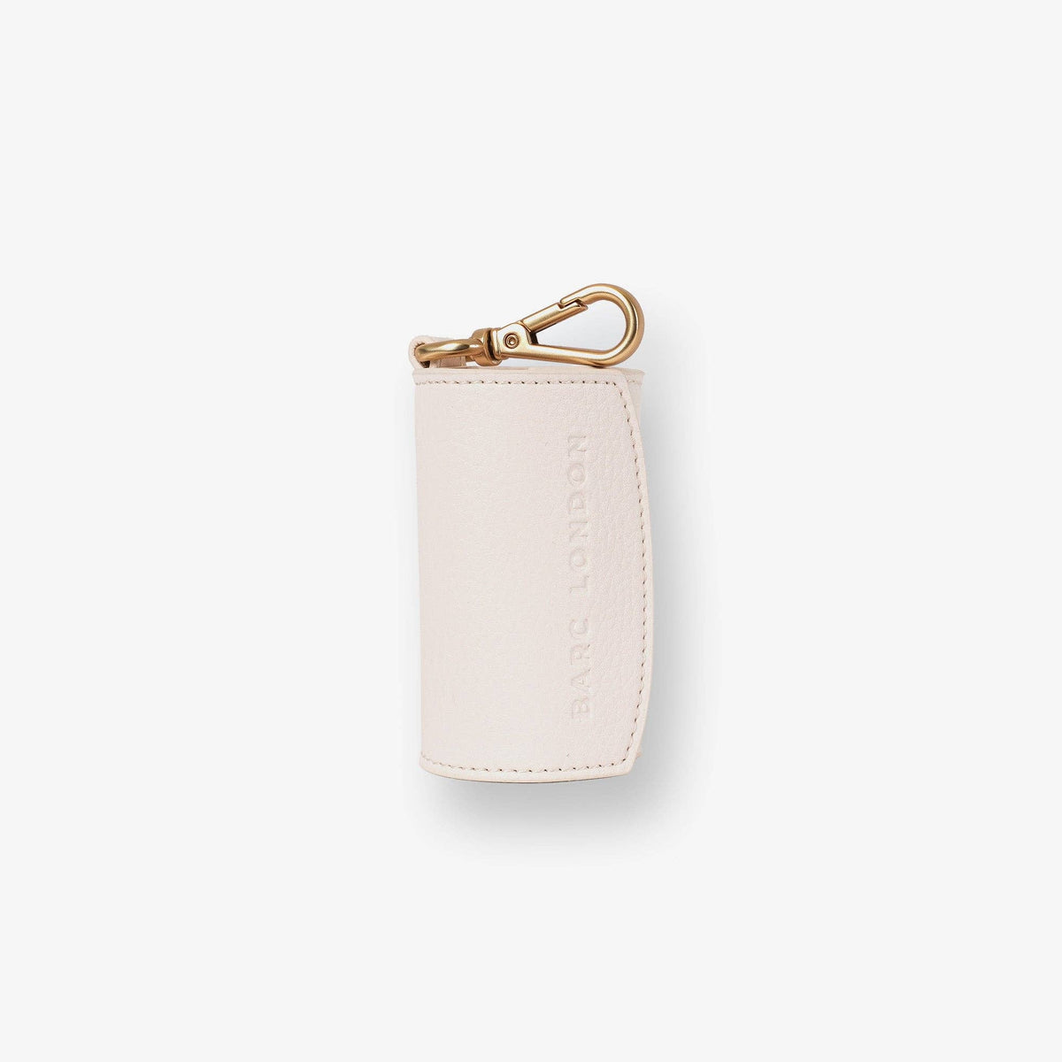Barc London ivory vegan leather dog waste bag holder with gold-tone hardware.