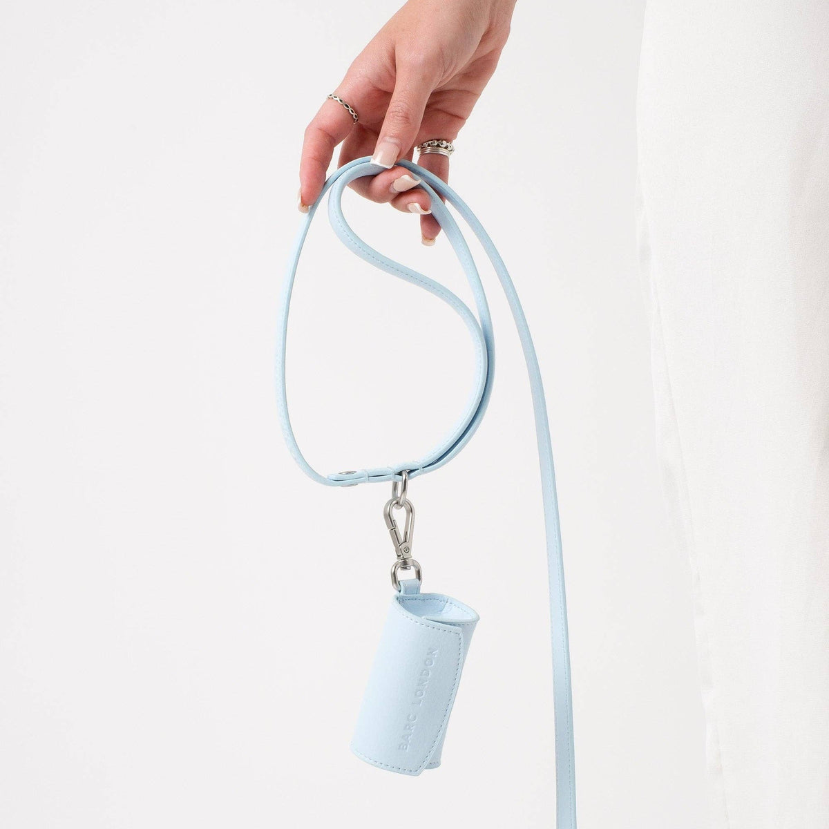 Light blue lanyard with a small pouch held by a hand on a white background