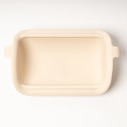 Rectangular beige ceramic dish on a white background
