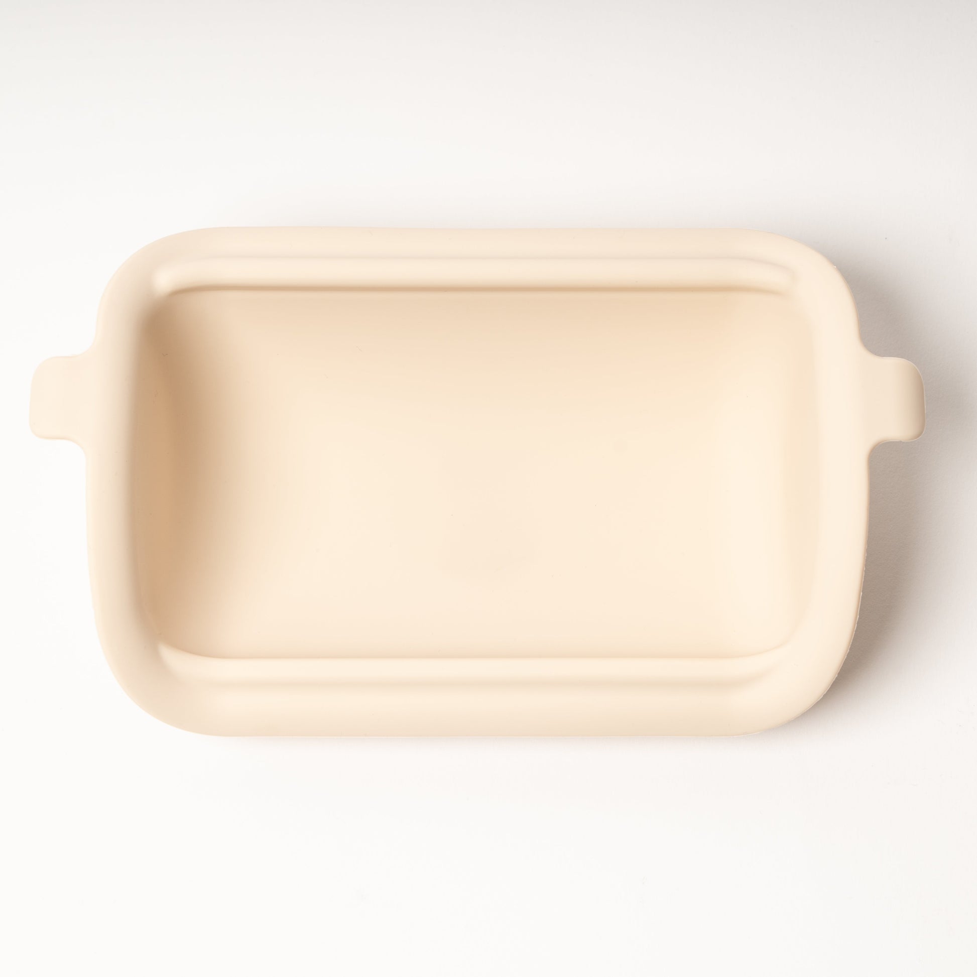 Rectangular beige ceramic dish on a white background