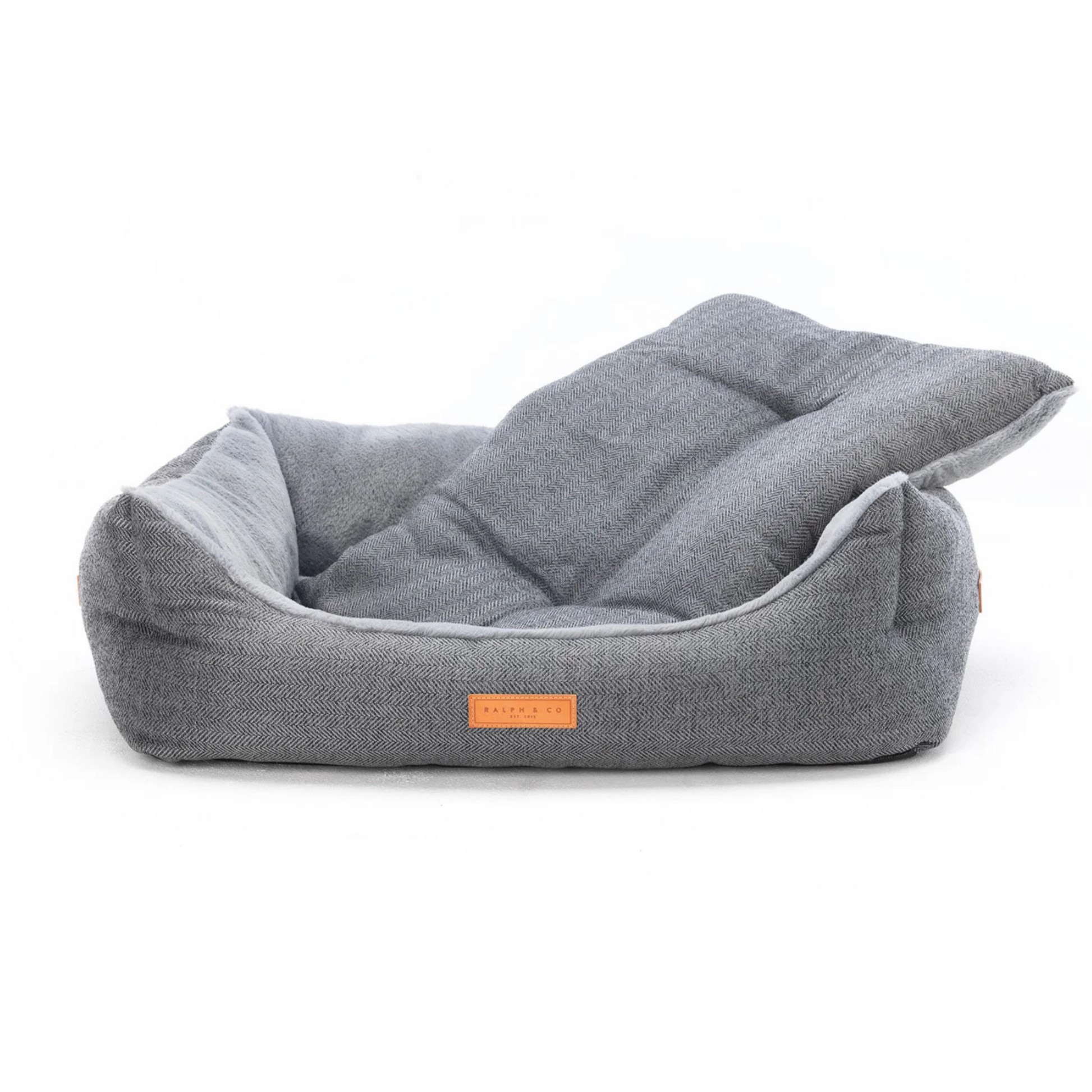 Gray pet bed with a brand label on a white background
