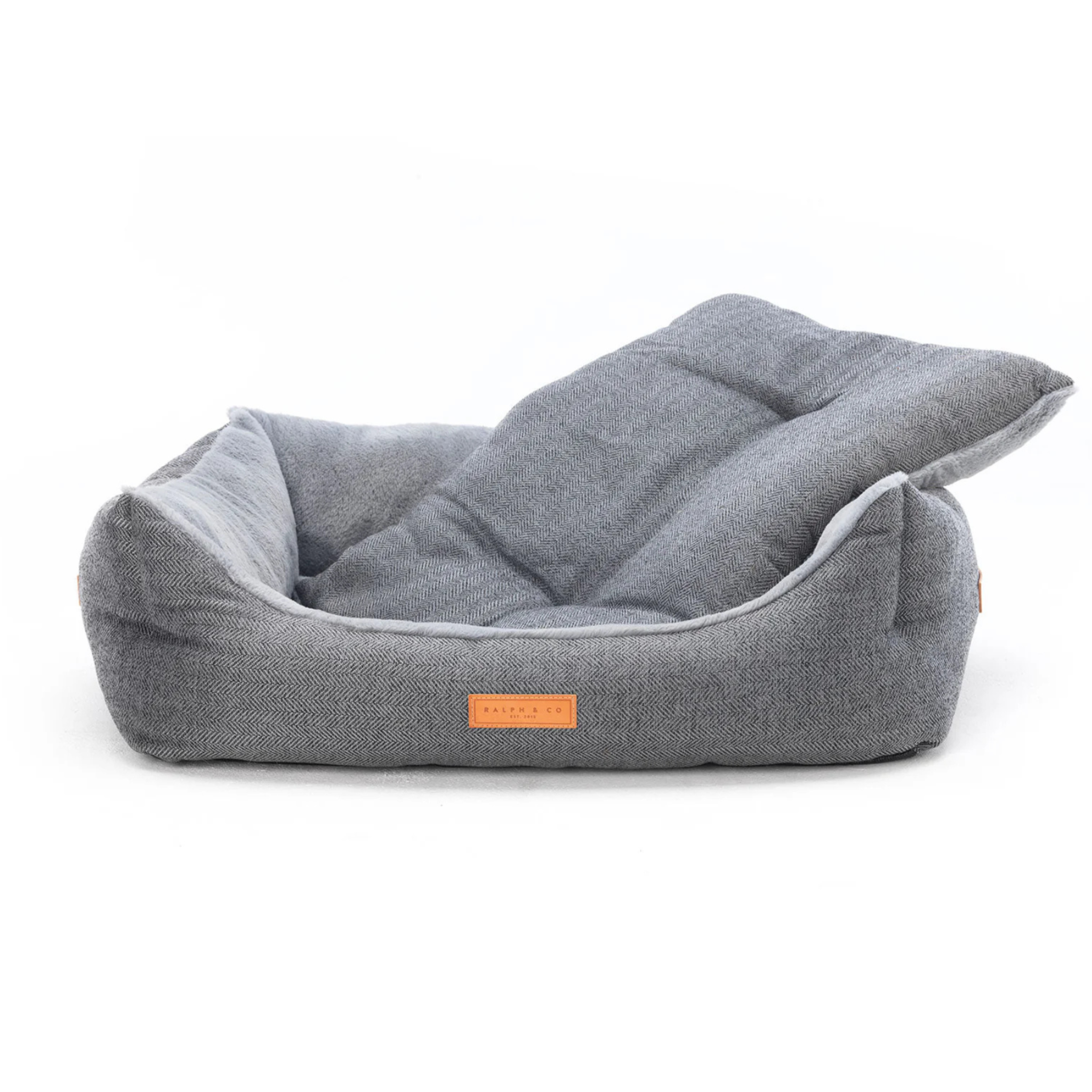 Gray pet bed with a brand label on a white background