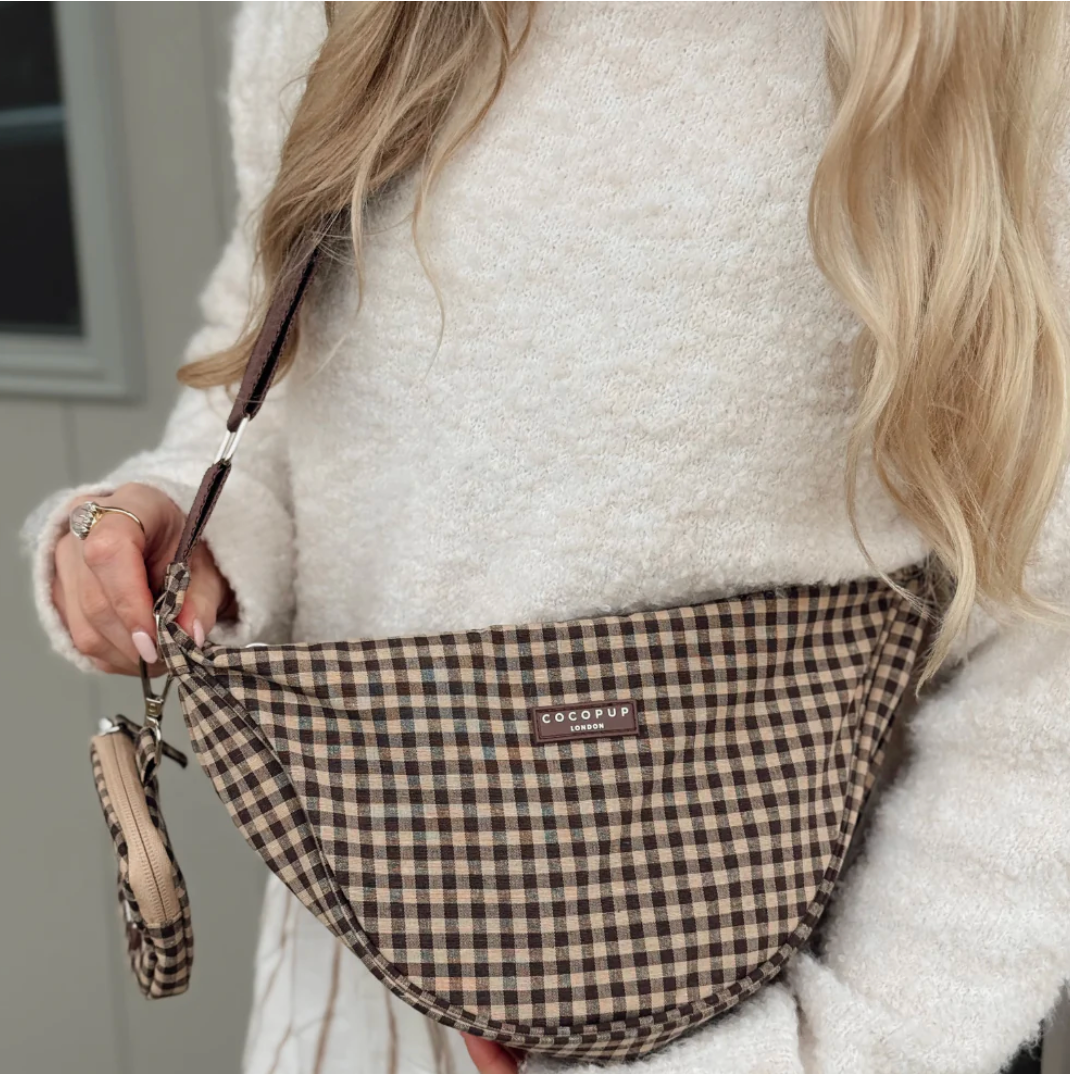 Brown check Cocopup dog walking bag worn crossbody with matching dog accessories.