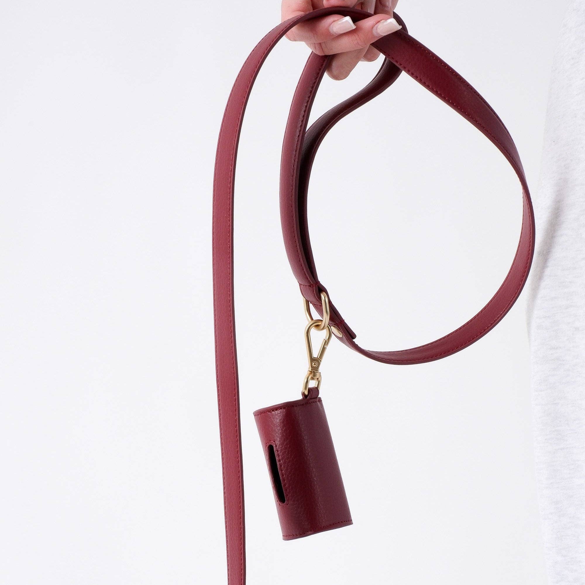 Burgundy dog walking lead with padded handle and gold-tone locking clasp.