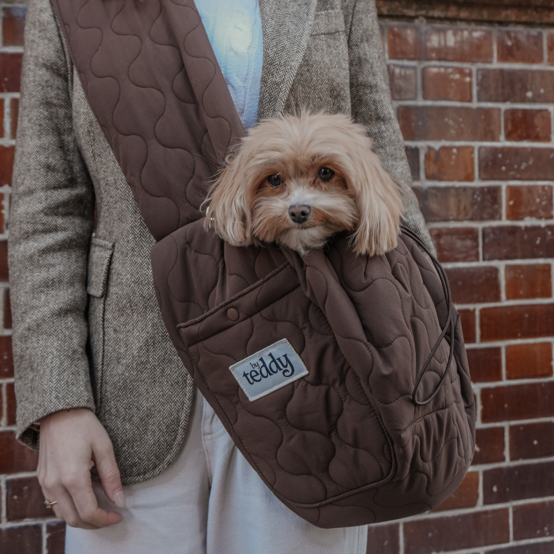 By Teddy Chocolate Quilted Sling worn as a comfortable crossbody dog carrier