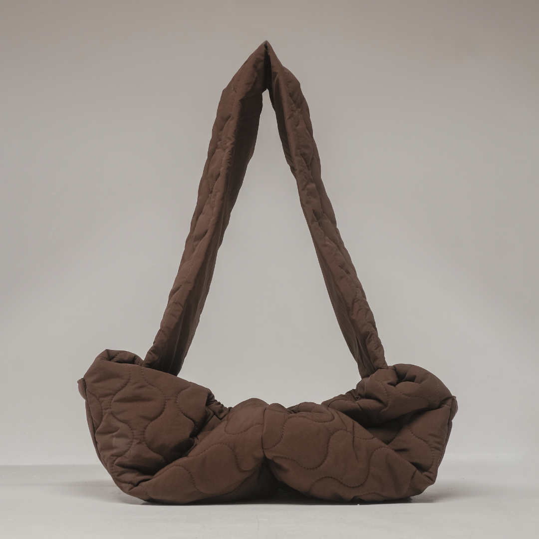 Spacious quilted interior of the By Teddy Chocolate Quilted Sling