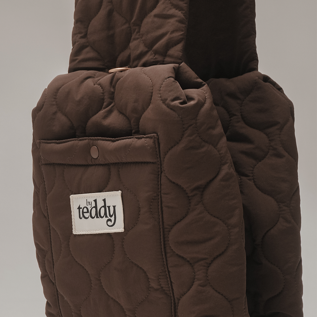 Storage pocket detail on the By Teddy Chocolate Quilted Sling with matte gold hardware