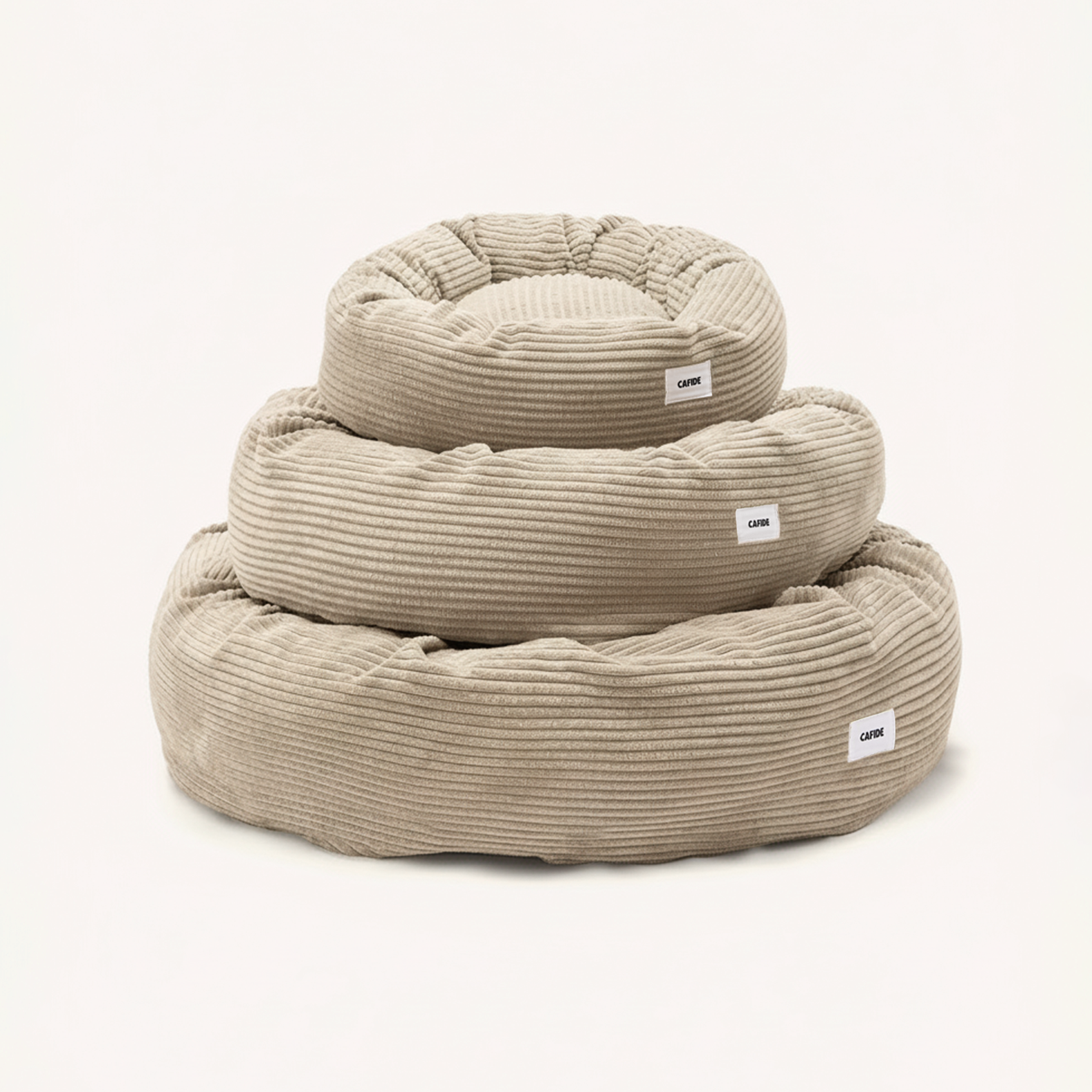 CAFIDE Nuba round beige corduroy dog bed with supportive recycled foam filling.