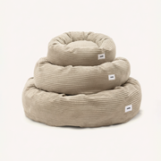 CAFIDE Nuba round beige corduroy dog bed with supportive recycled foam filling.