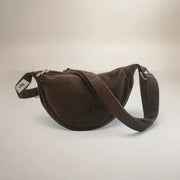 Brown suede crossbody bag on a light gray background