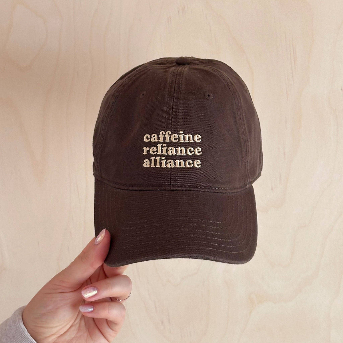 Relaxed cotton baseball cap with embroidered Caffeine Reliance Alliance slogan.