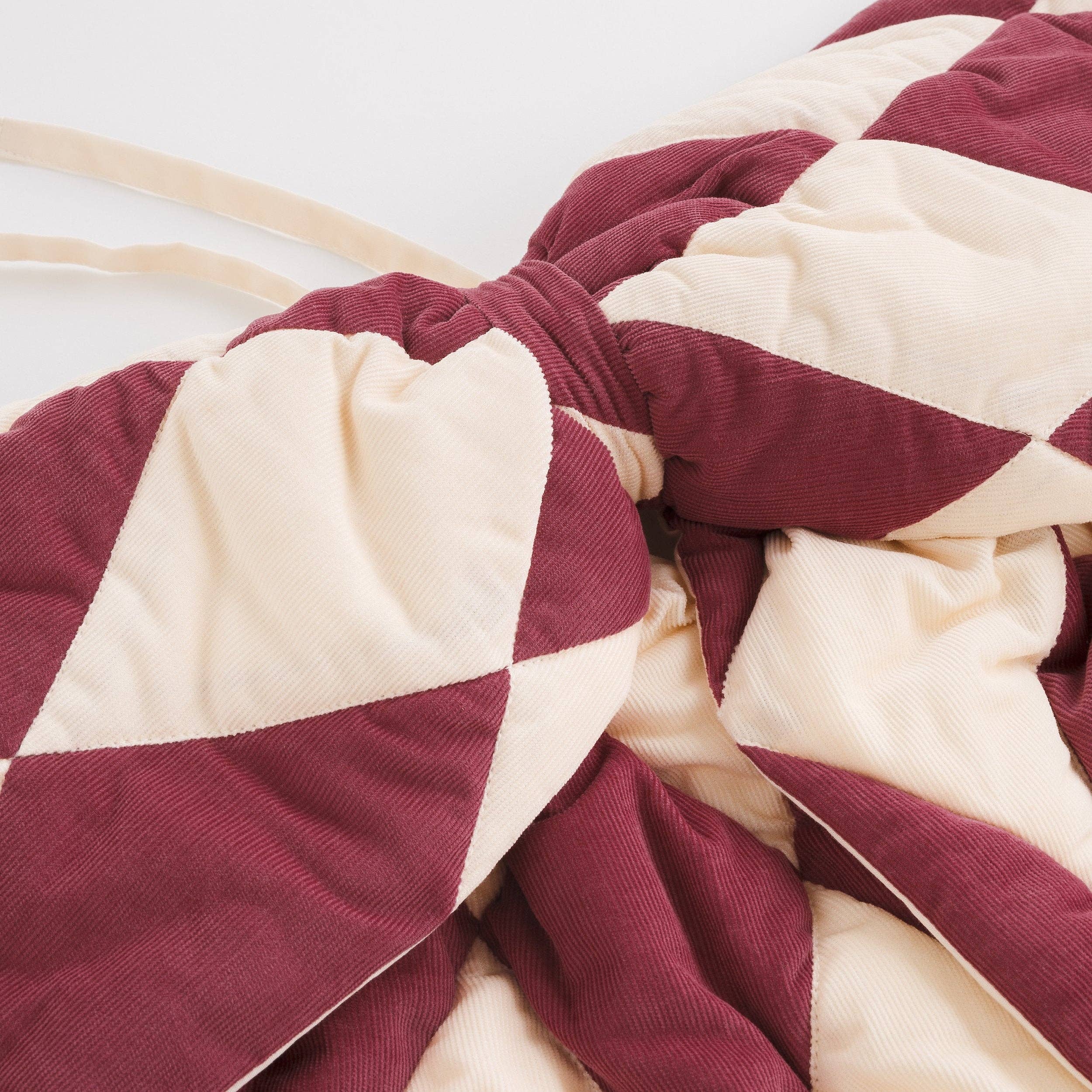 Quilted claret and cream Harlequin fabric bow for colourful designer interiors.