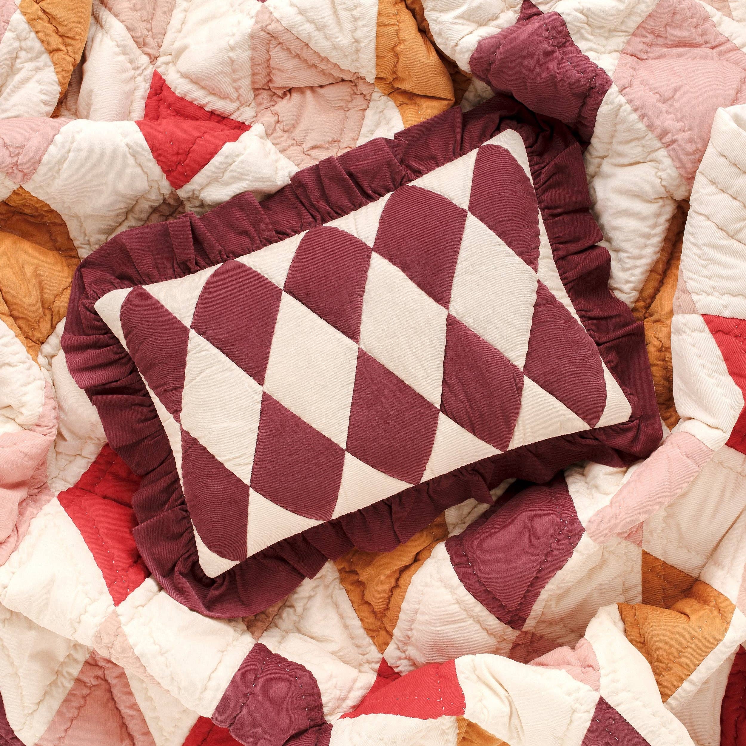 Claret and cream Harlequin designer cushion in soft cotton corduroy.