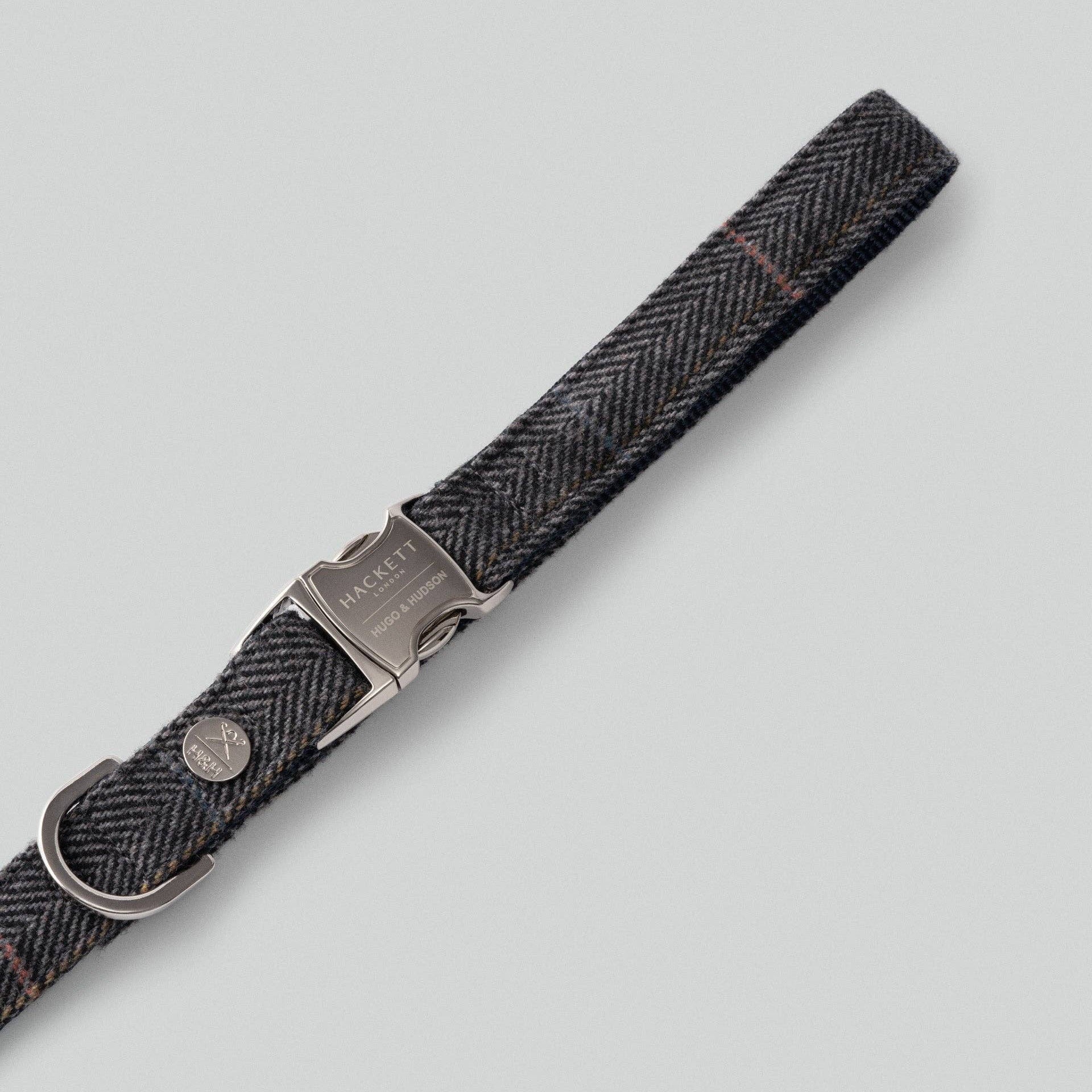 Close-up detail of grey checked herringbone tweed fabric on luxury dog lead