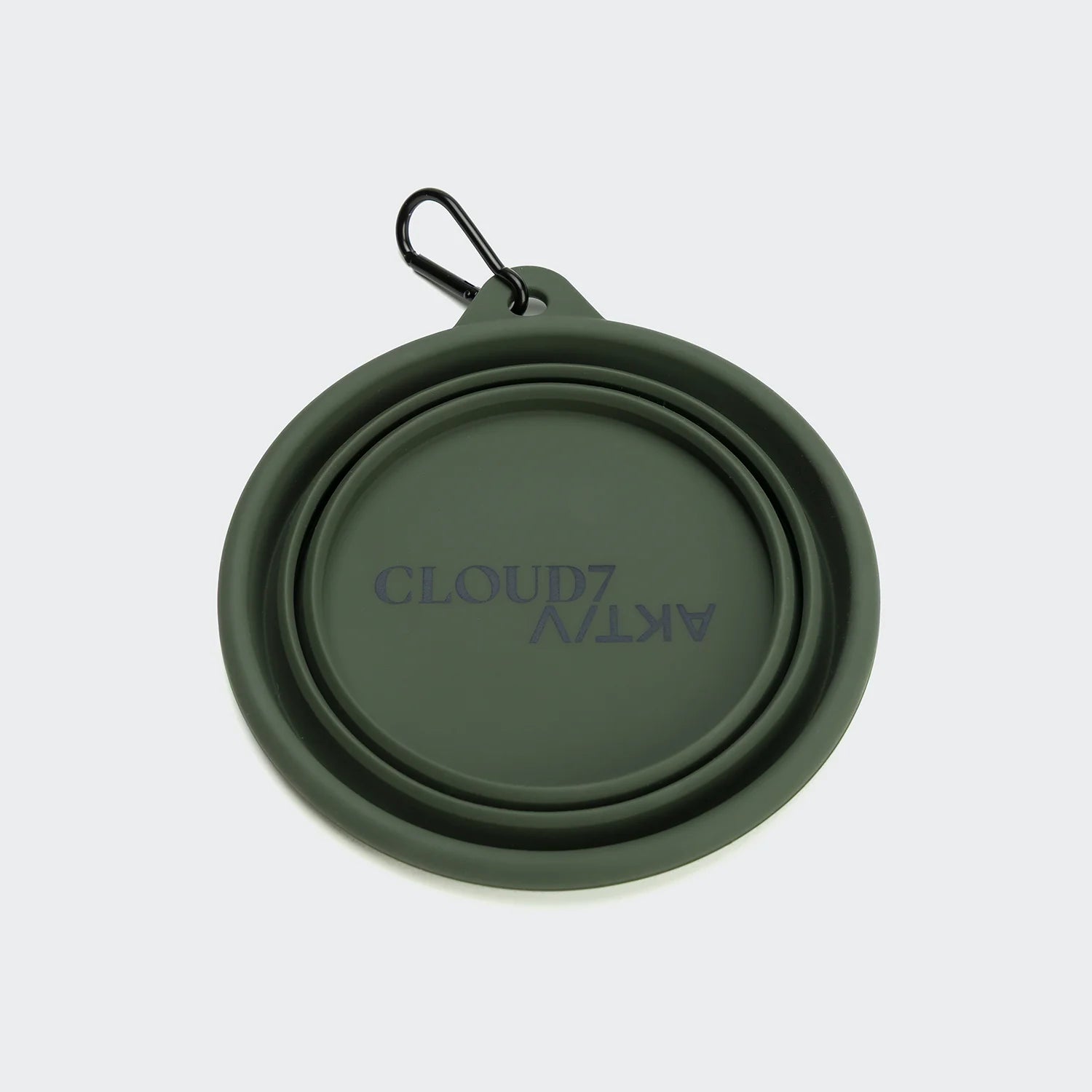 Green silicone travel mug with 'Cloud7' branding on a light purple background