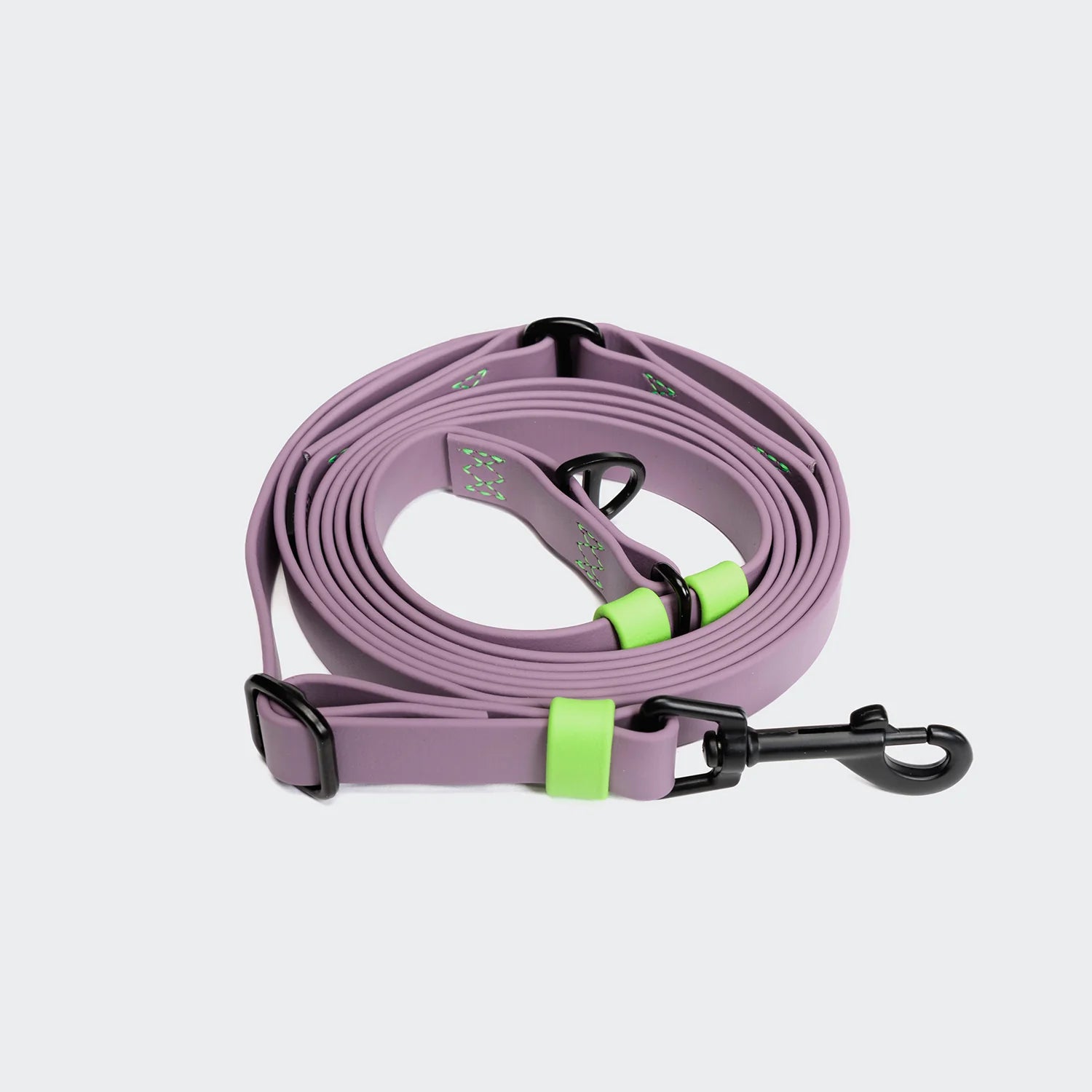 Purple dog leash with green accents on a light gray background