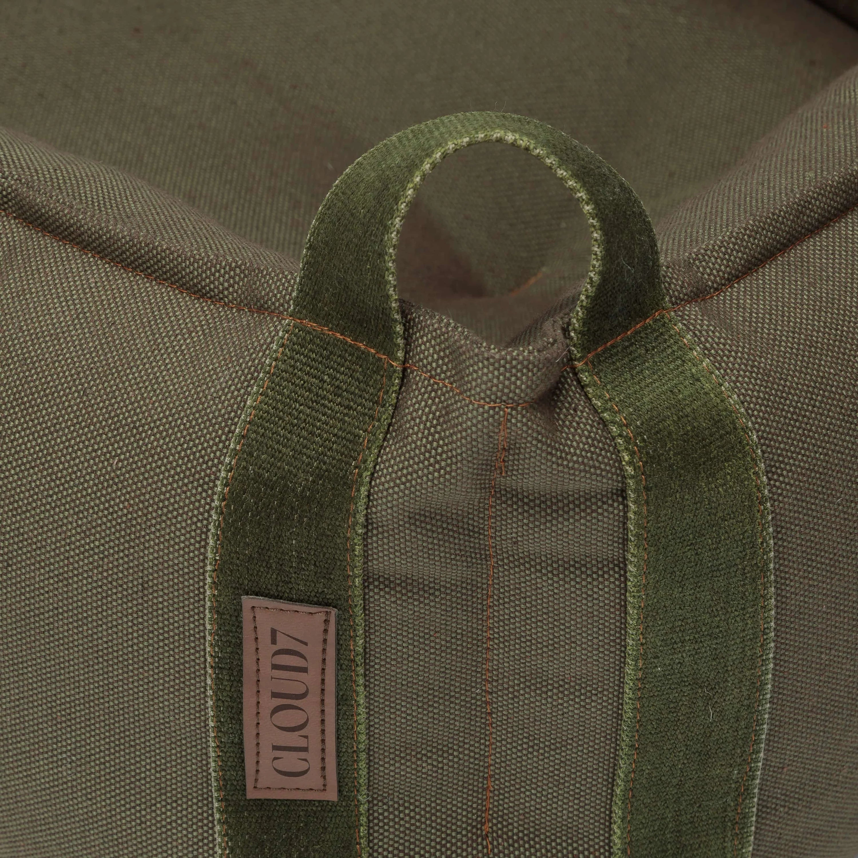 Premium bolster-style dog bed with supportive cushioning and olive canvas fabric.