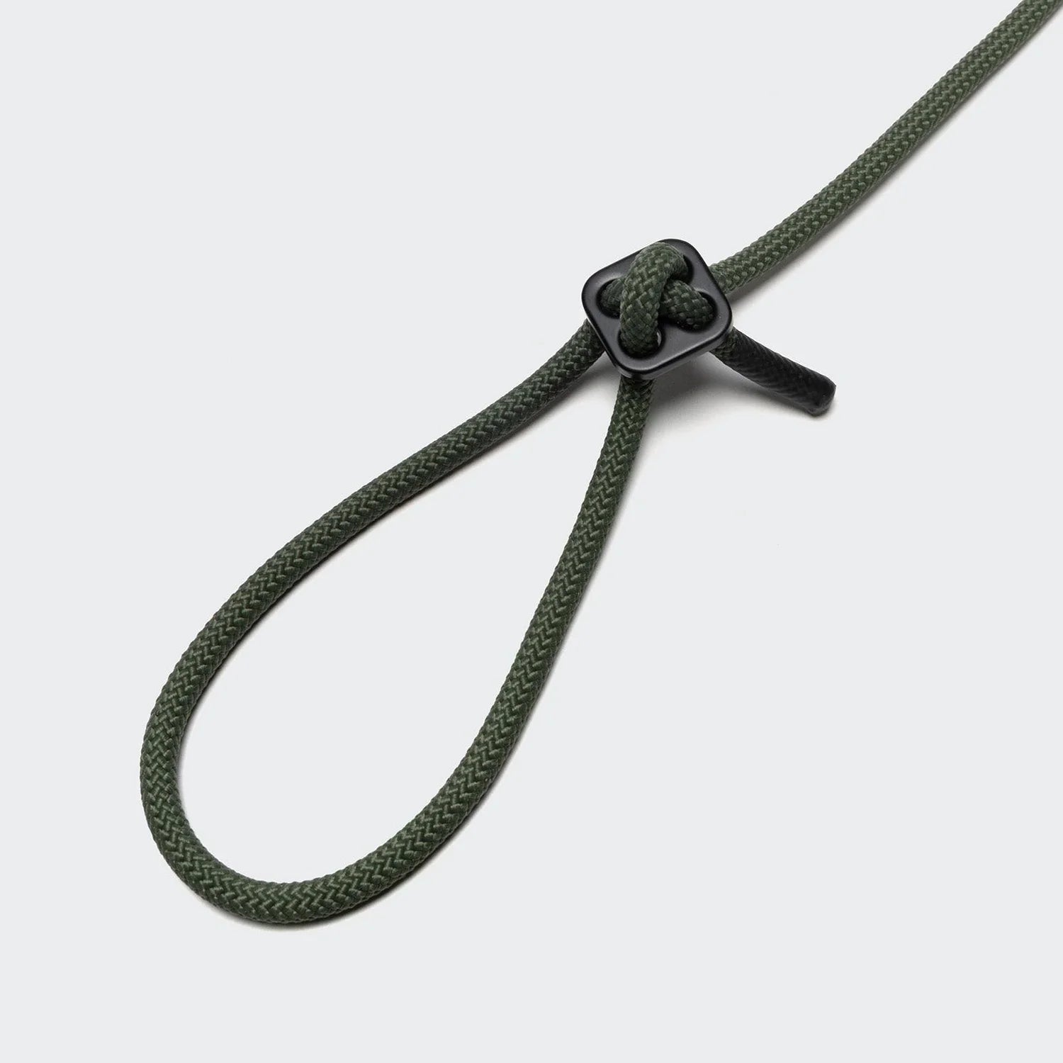 Cloud7 Rope Leash LTTL Dark Olive worn crossbody for hands-free dog walking convenience.