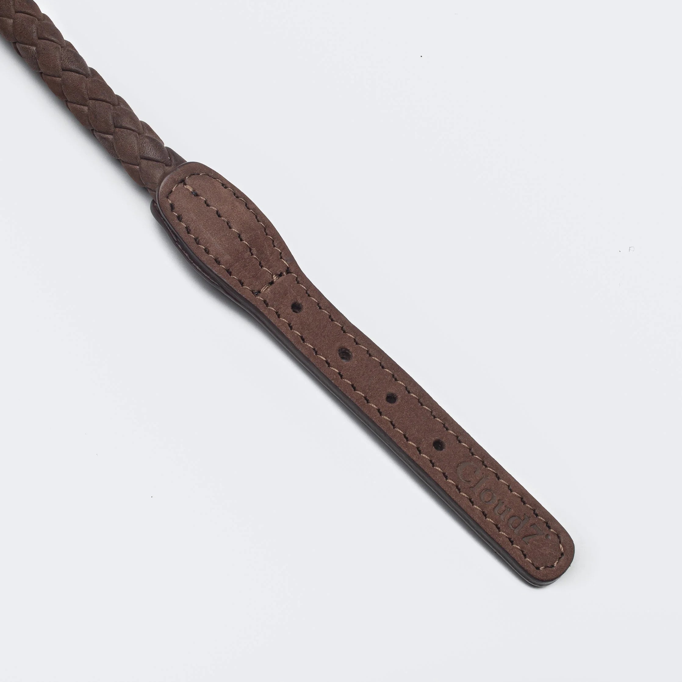Brown leather strap on a light gray background