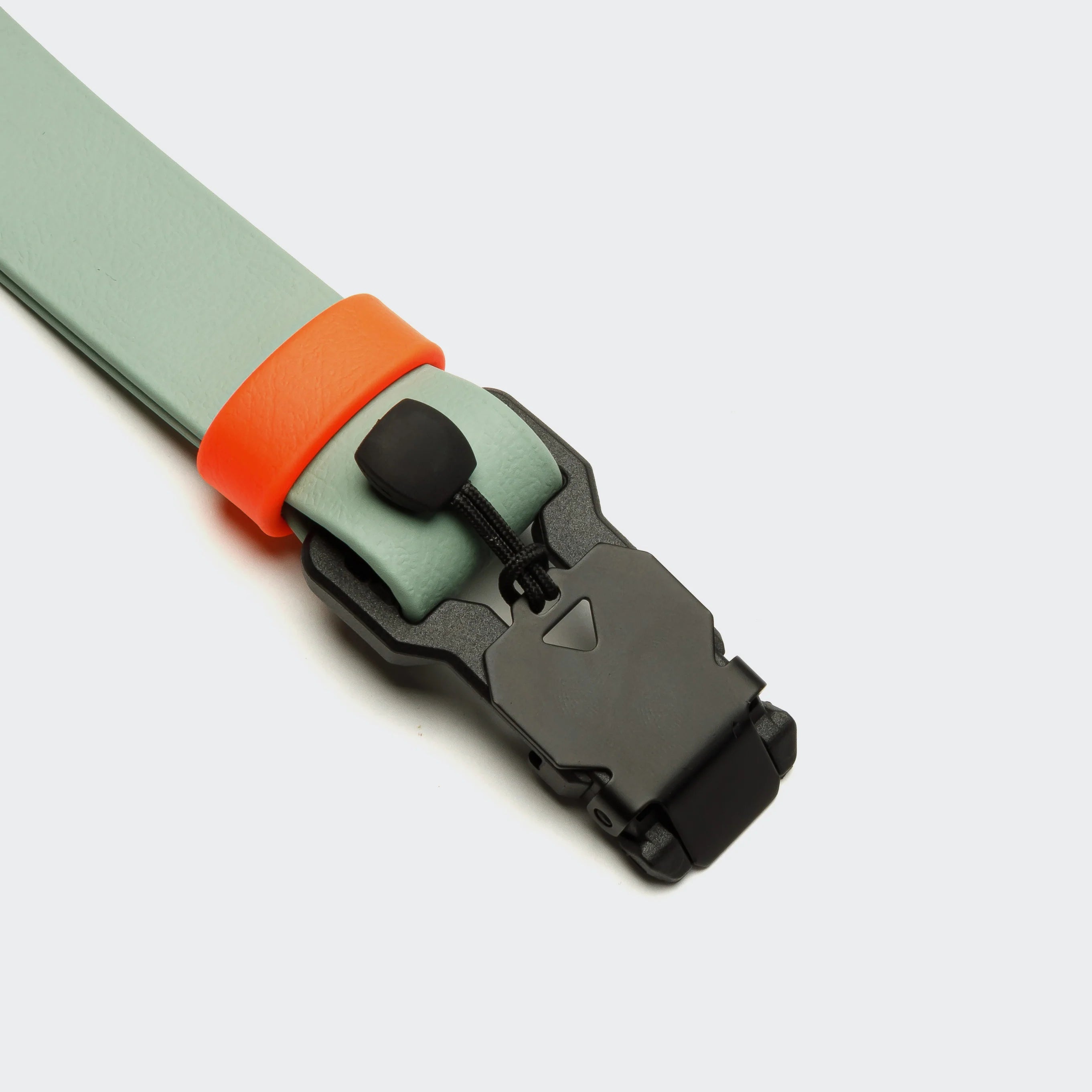Light green belt with an orange buckle and black buckle on a light gray background