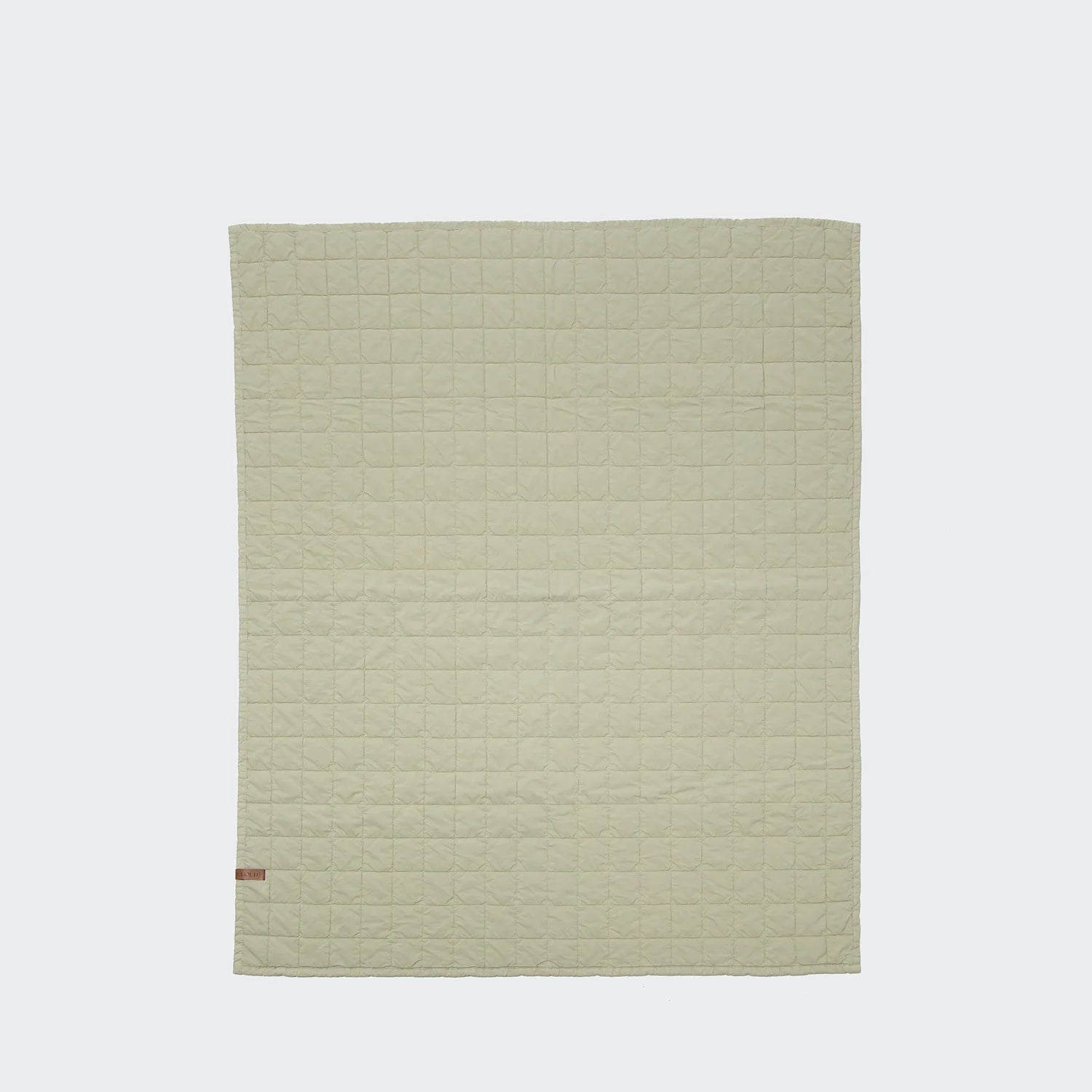 Quilted dog blanket with lightweight padding designed for home and travel use.