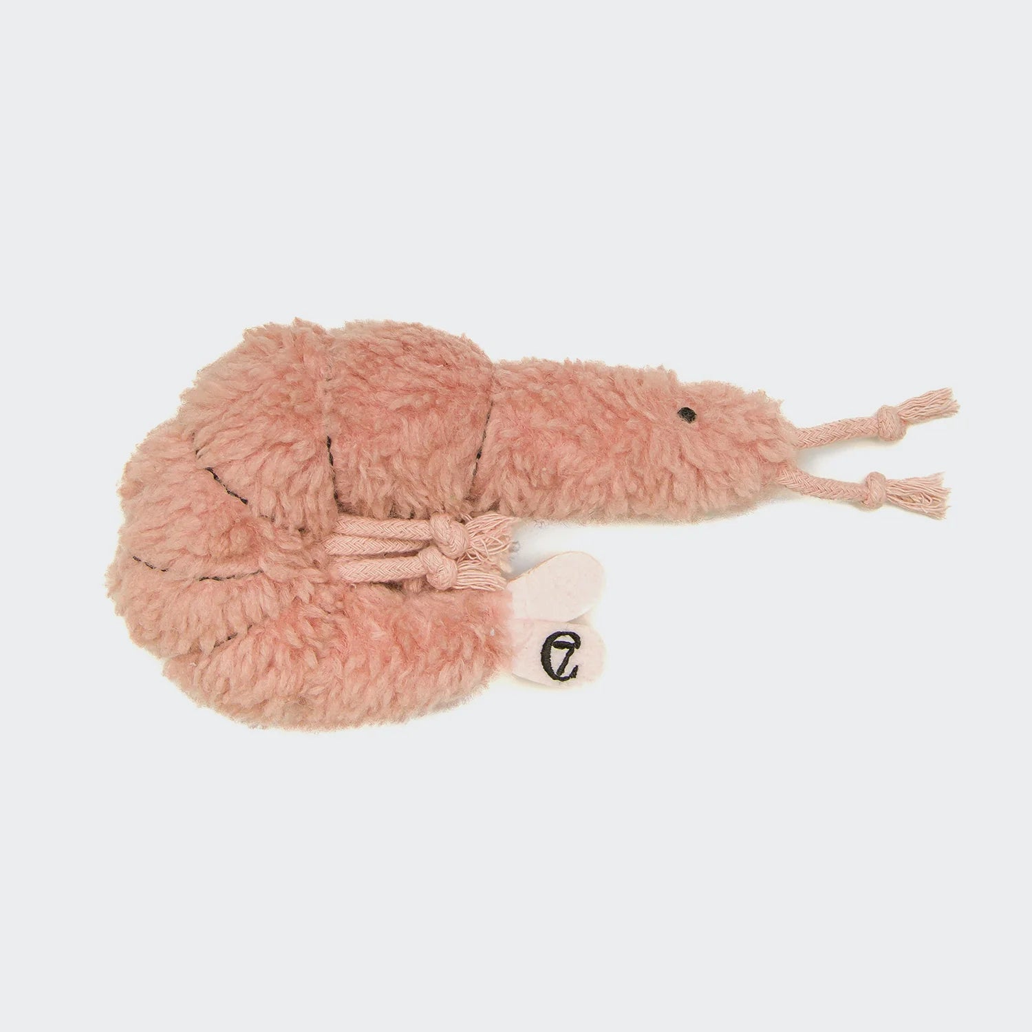 Pink plush toy resembling a snake on a light gray background