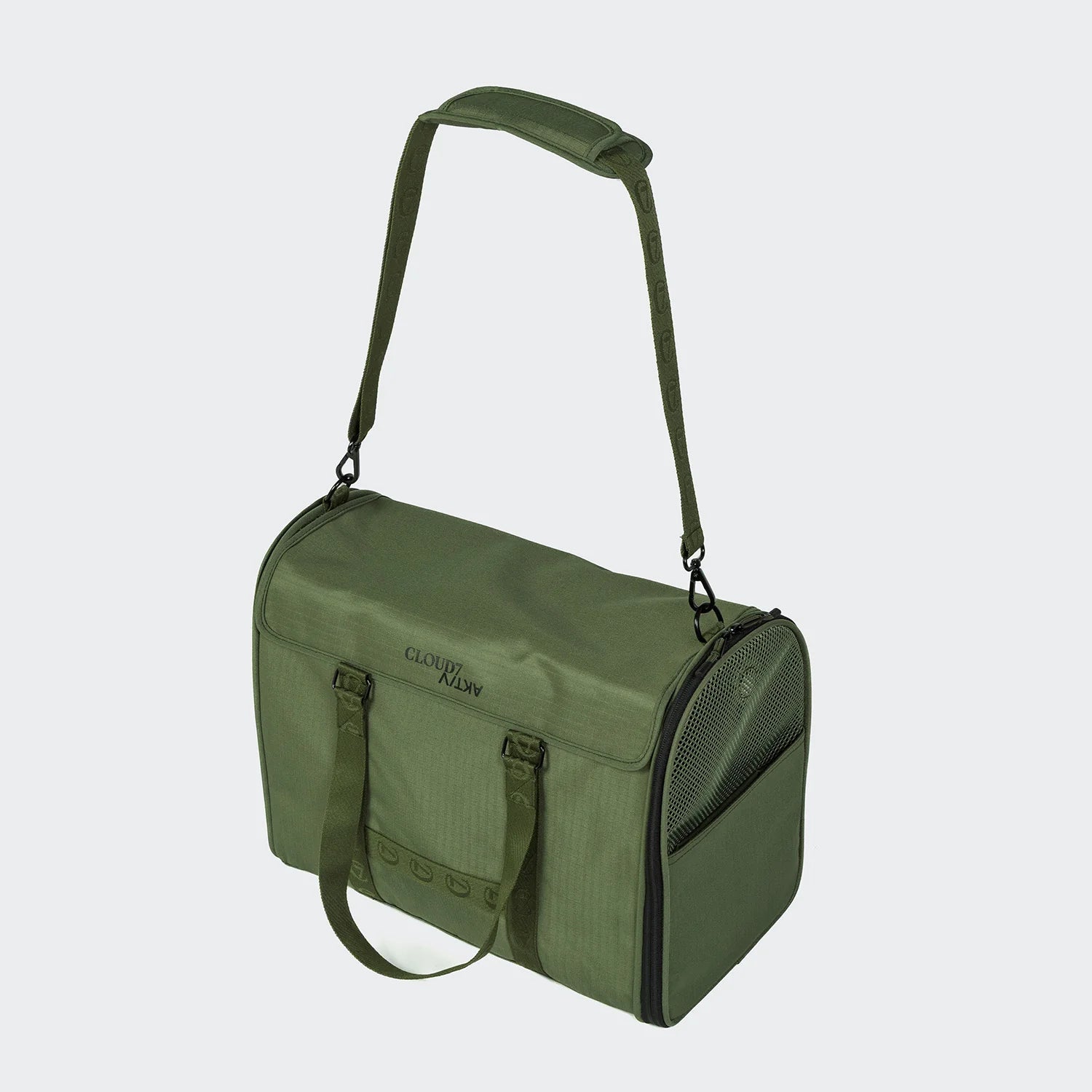 Green pet carrier with a handle on a light gray background