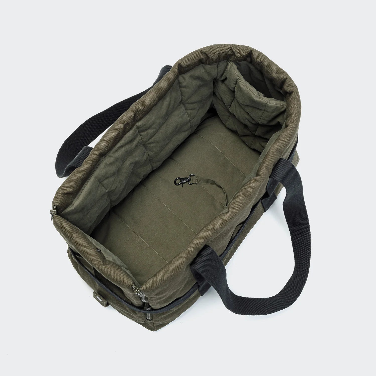 Green bag with black straps on a white background