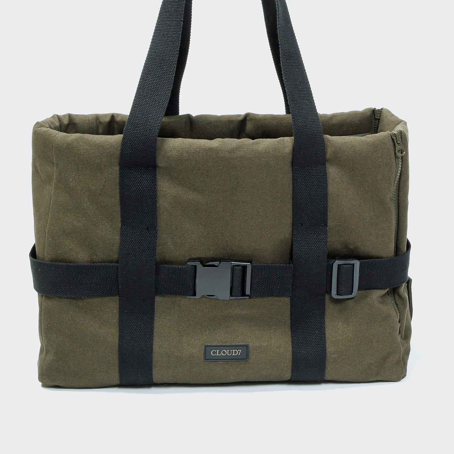 Green tote bag with black straps and a visible brand logo on a white background