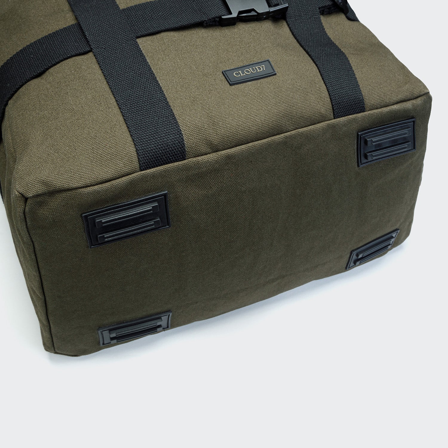 Green duffel bag with black straps and visible brand logo on a white background