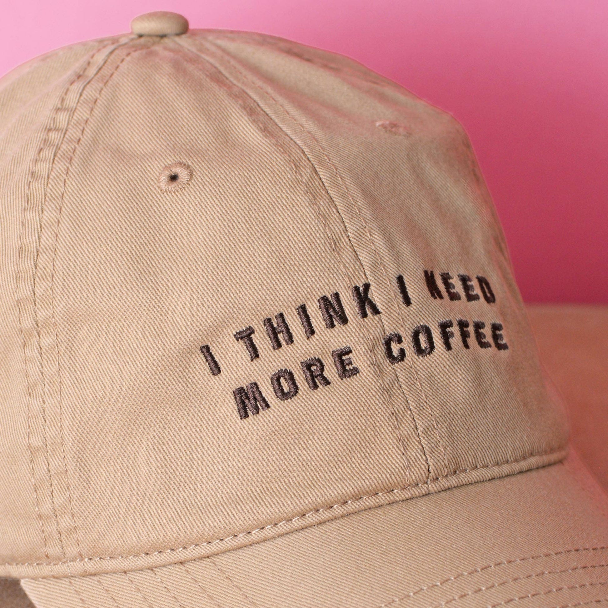I Think I Need More Coffee embroidered Sand dad cap with adjustable fit.