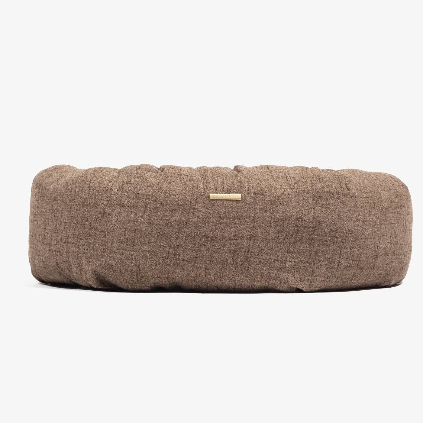 Brown textured dog bed on a white background