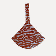 DOGGUO Ethnic dog carrier bag in peach and bordeaux with a wide shoulder strap.