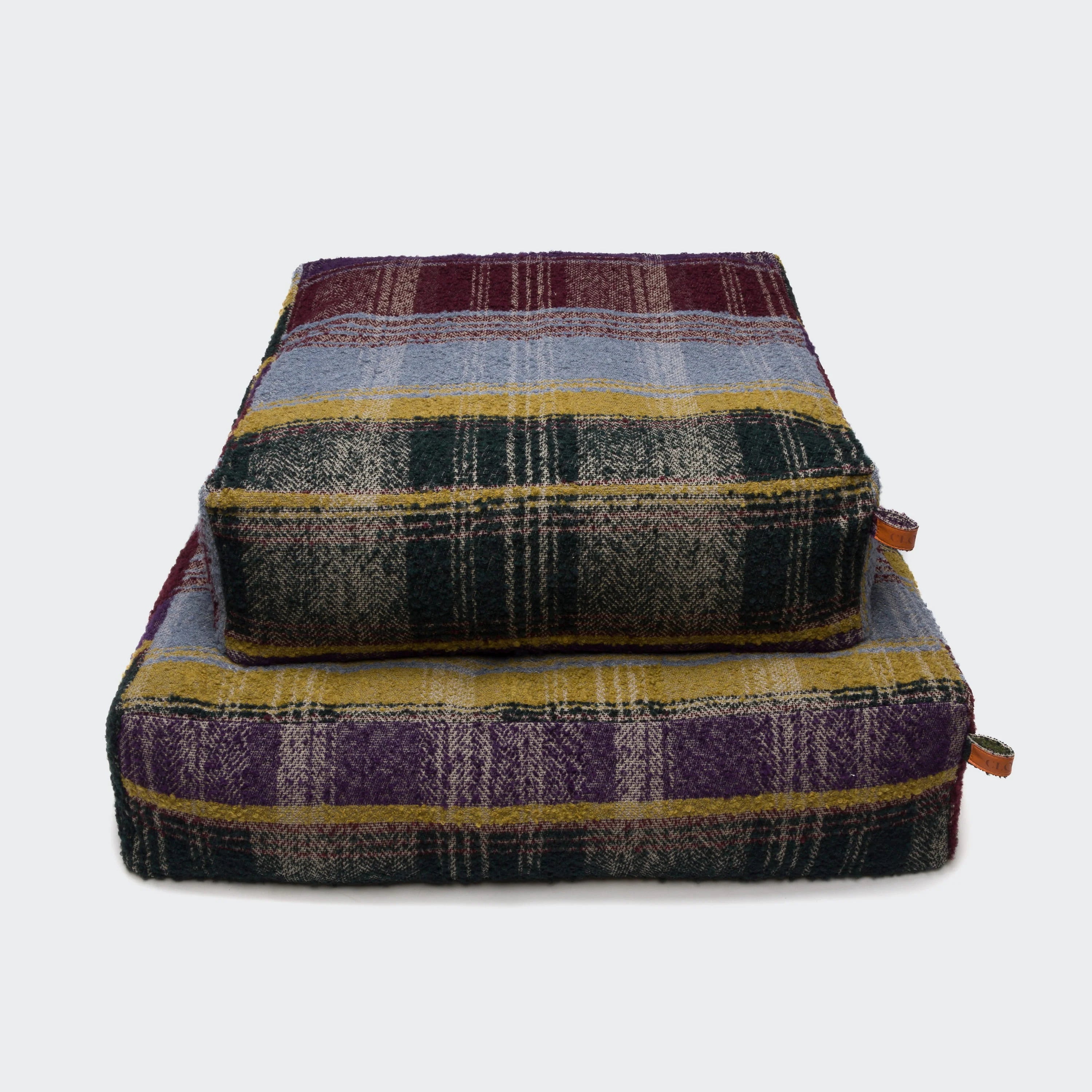 Plaid patterned pet bed on a white background