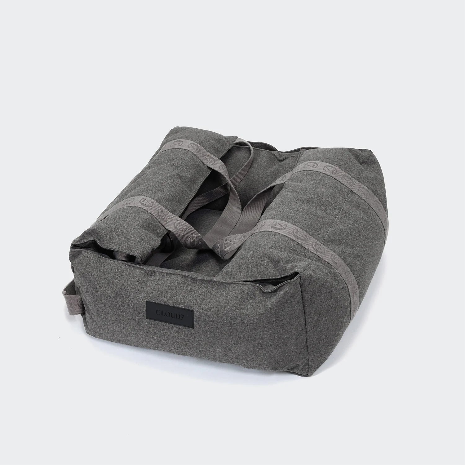 Gray duffel bag with a visible brand label on a light gray background