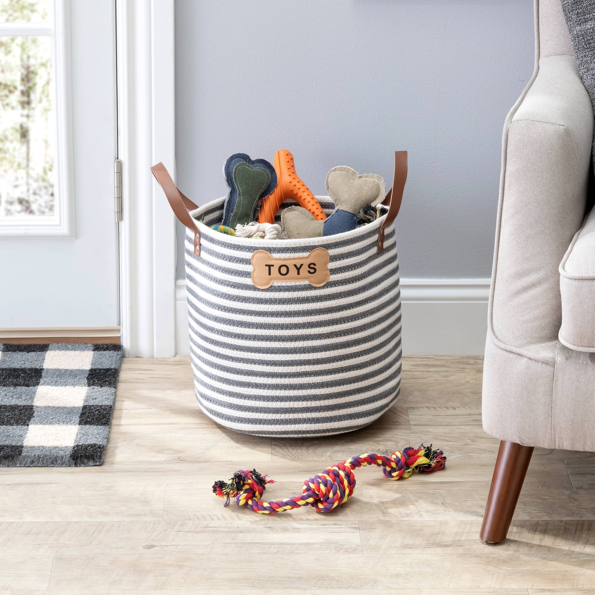 Contemporary dog toy storage basket with integrated carrying handles.