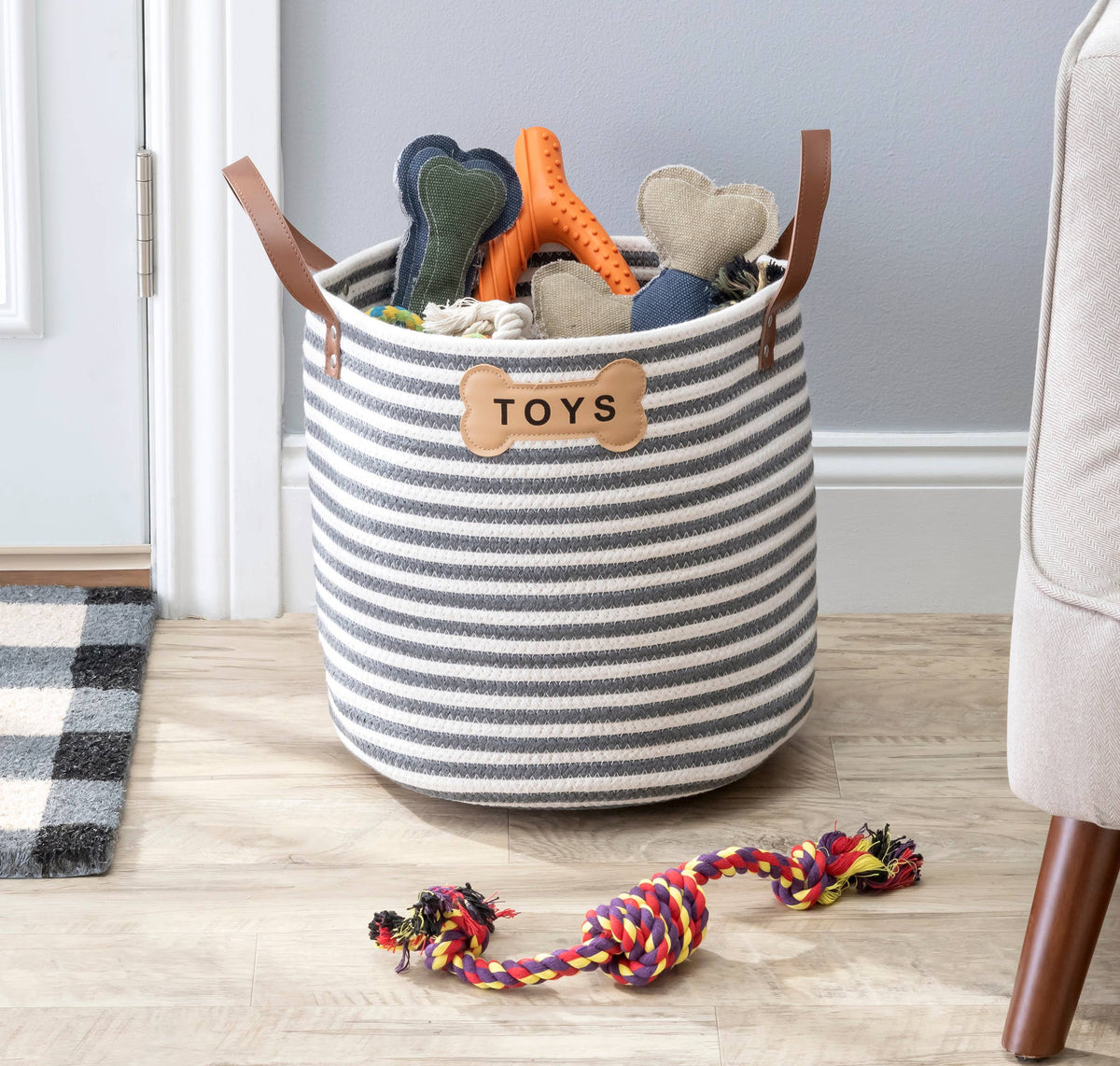Contemporary dog toy storage basket with integrated carrying handles.