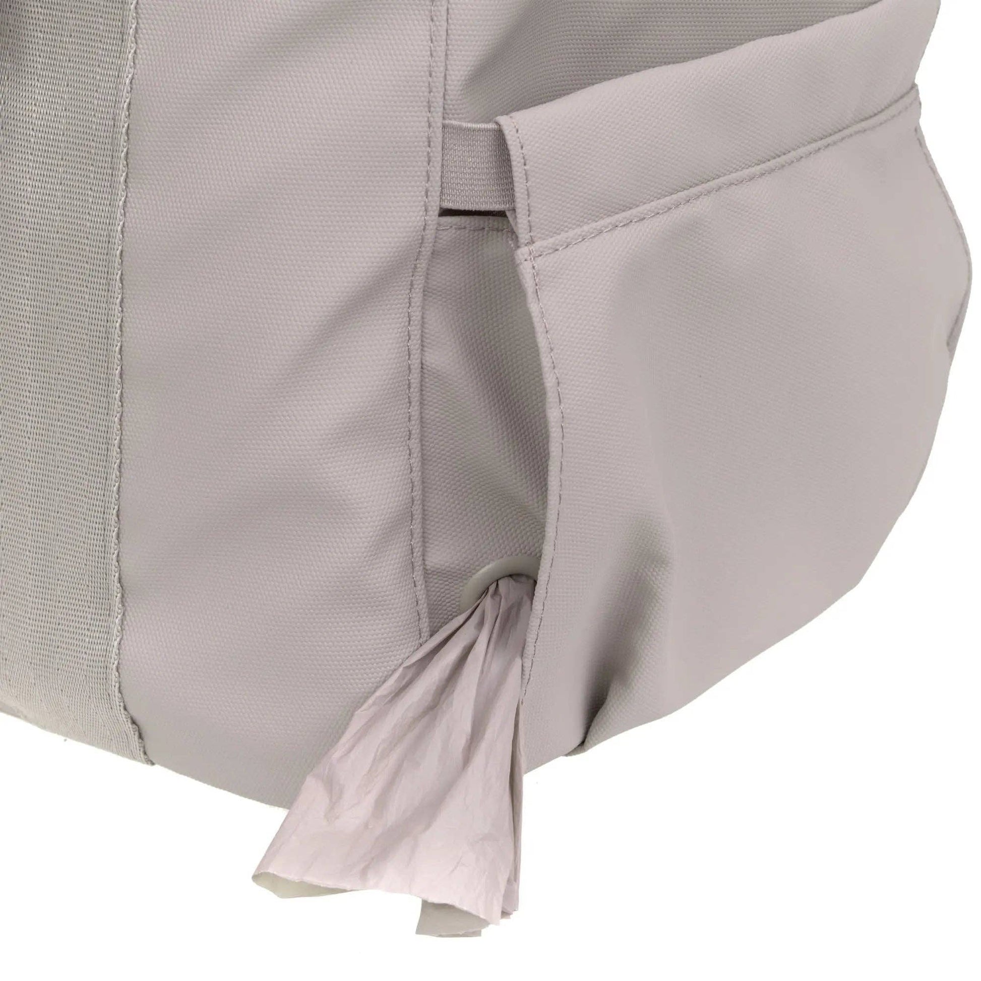 Dog travel carrier with flexible mesh cover providing ventilation and visibility during journeys.