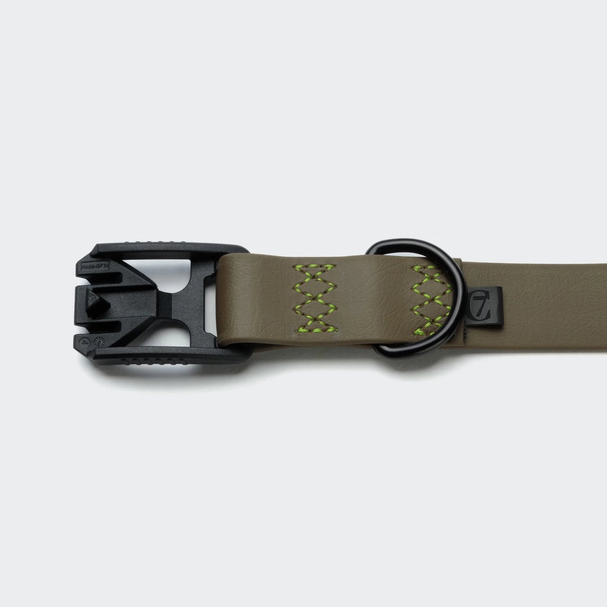 Dog collar with black metal buckle on a light gray background