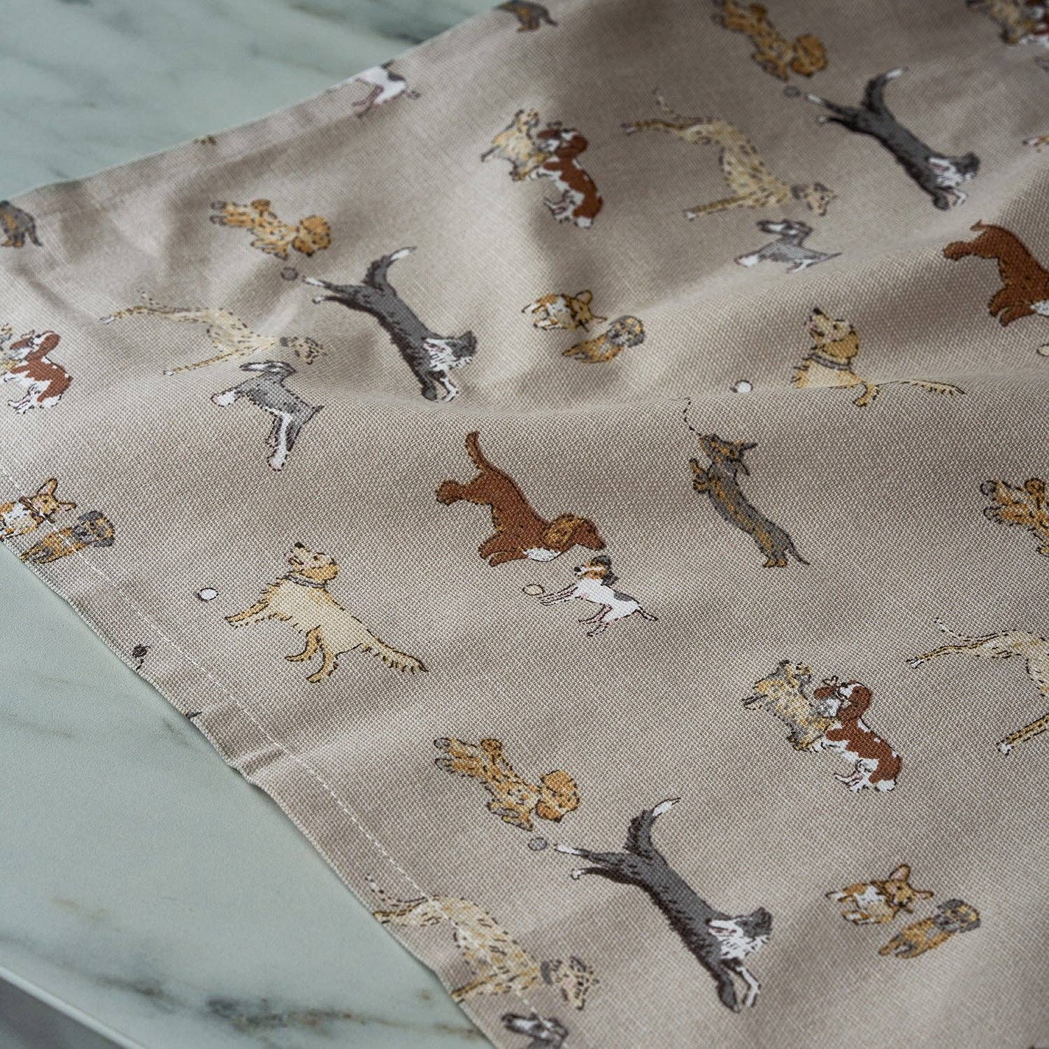 100% cotton tea towel with playful dog illustrations for stylish kitchens.