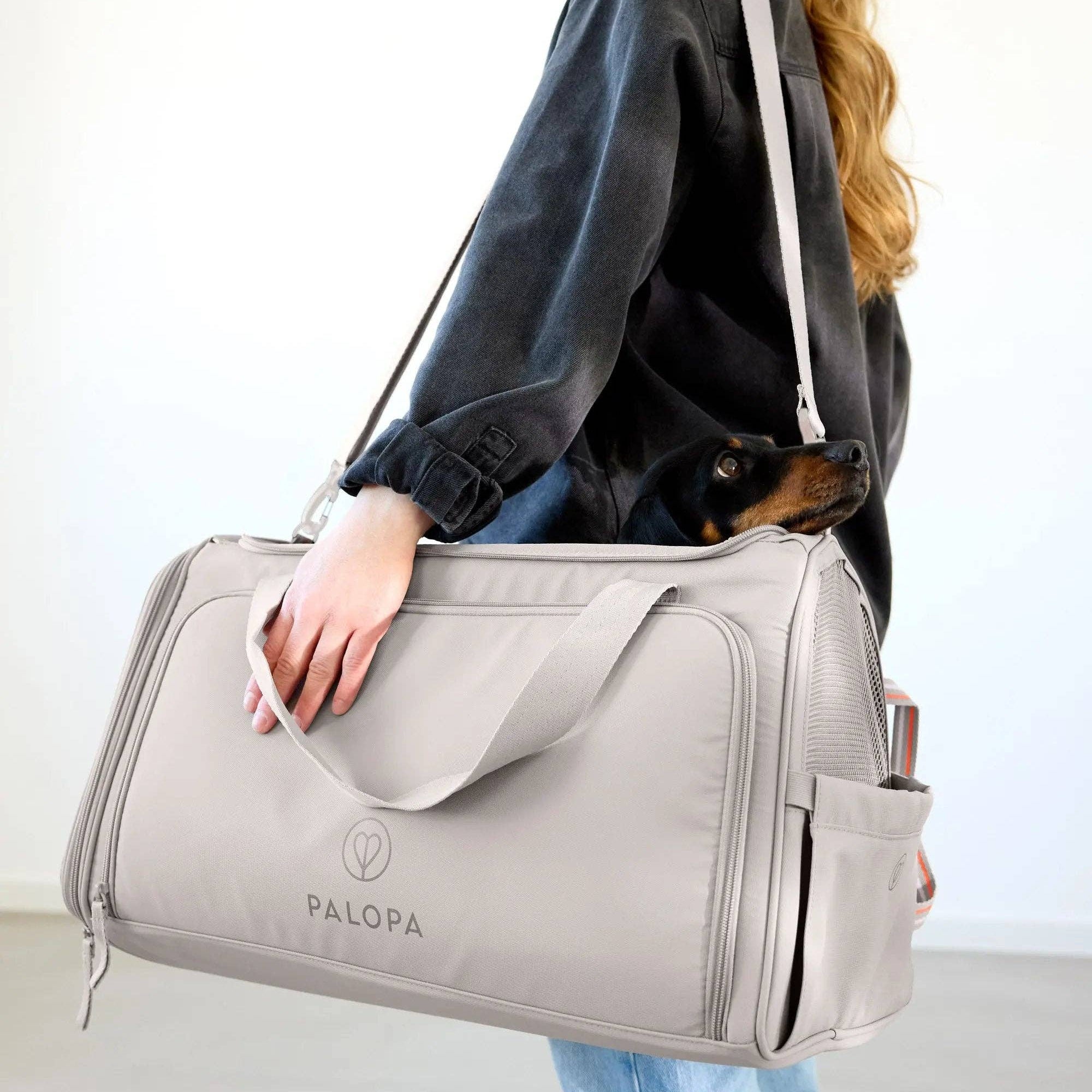 Taupe dog travel carrier made from recycled materials with water-resistant coating and practical storage pockets.
