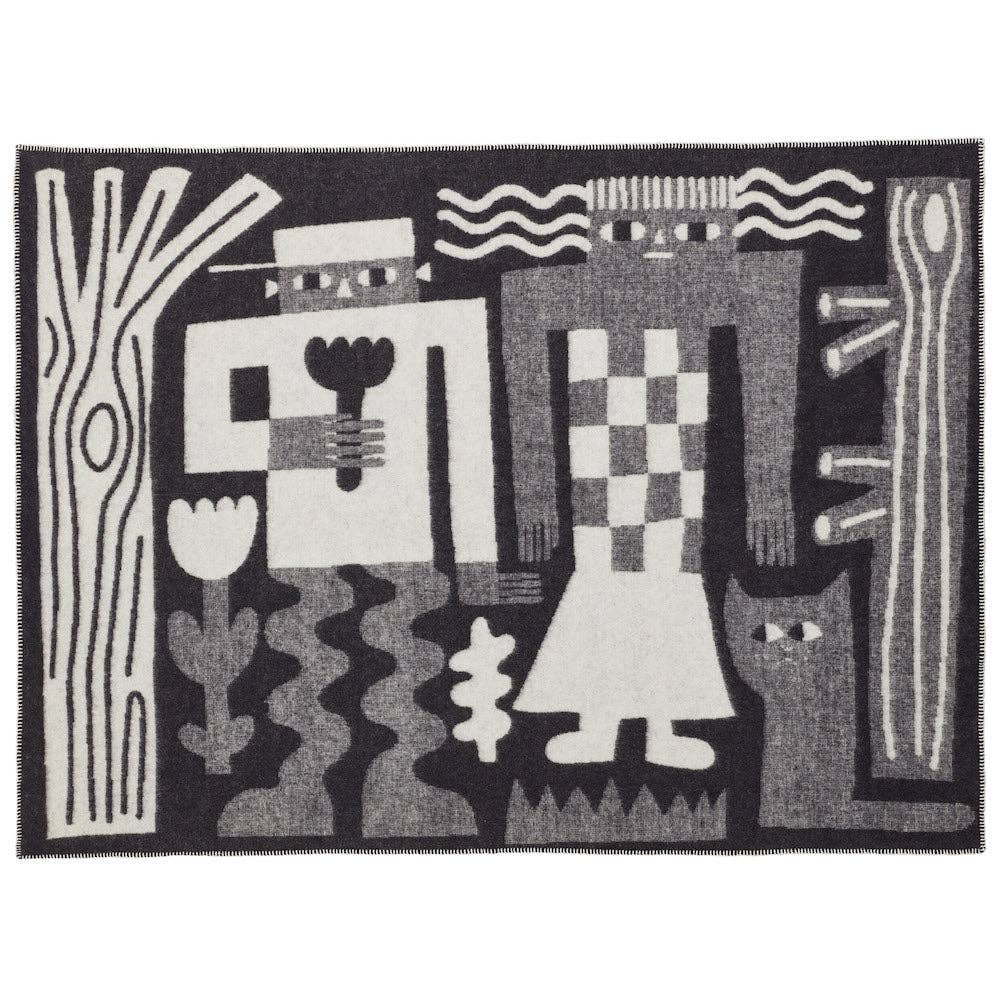 Donna Wilson Me and You designer wool blanket draped across a contemporary sofa.