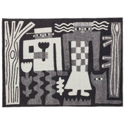 Donna Wilson Me and You designer wool blanket draped across a contemporary sofa.