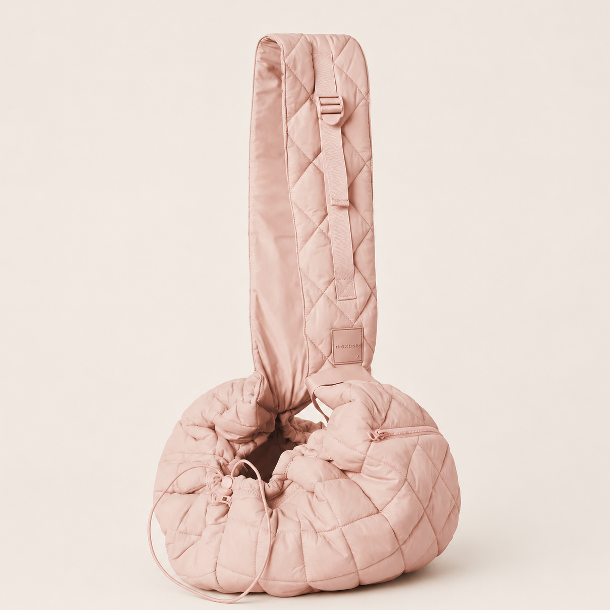 Pink quilted bag on a beige background