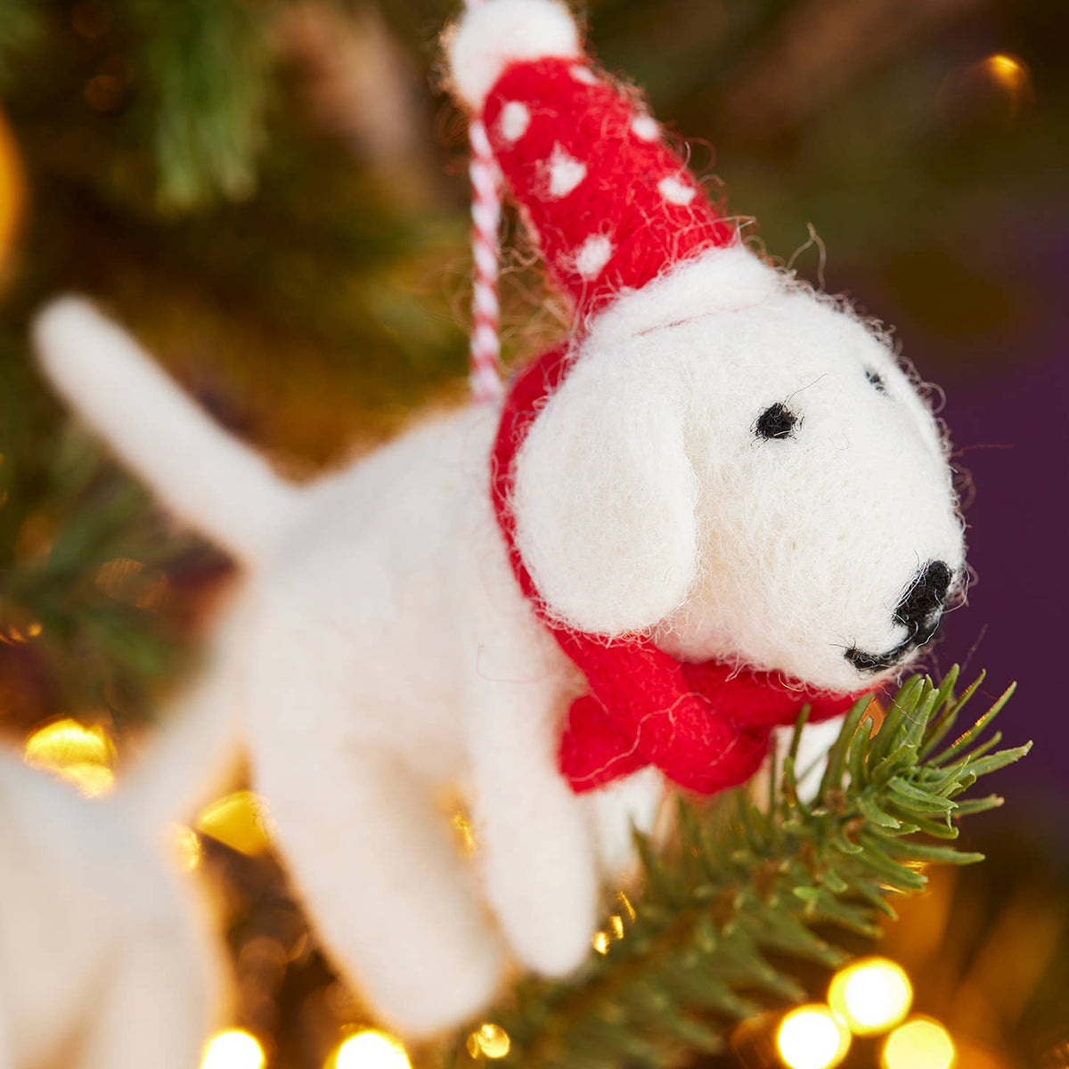 Handmade felt dog wearing a spotty Christmas hat and tie